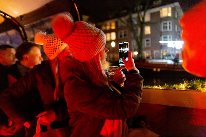 Amsterdam Evening Canal Cruise with Live Guide and Onboard Bar - Drinks, commentary, and the onboard atmosphere