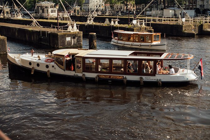 Amsterdam: Luxury Saloon Boat Cruise with Cocktails & Waffle - A gentle start at the Krasnapolsky dock