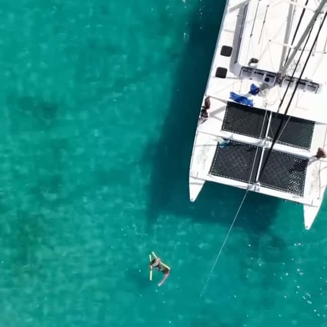 Barbados: Catamaran Tour with Snorkeling and Lunch - Lunch on deck, with Barbados on the horizon