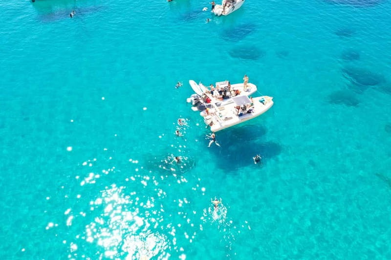 Cagliari: Boat Tour, 4 Stops, Swim, Snorkeling, & 1 Spritz - Speeding past the port and watching for dolphins