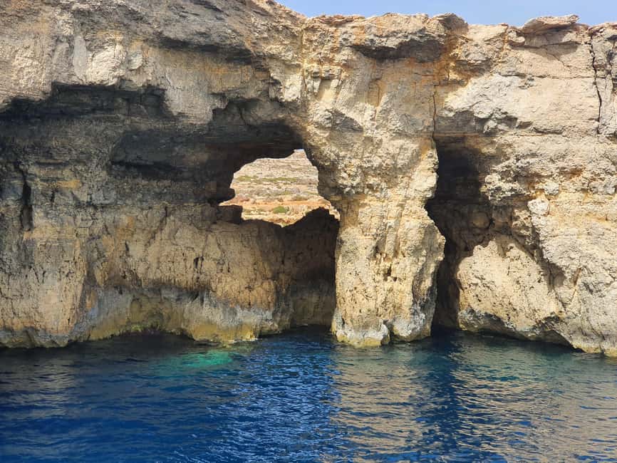 Comino: Blue Lagoon & Caves Boat Cruise - Deck chairs, shade, music, and pineapple cocktails