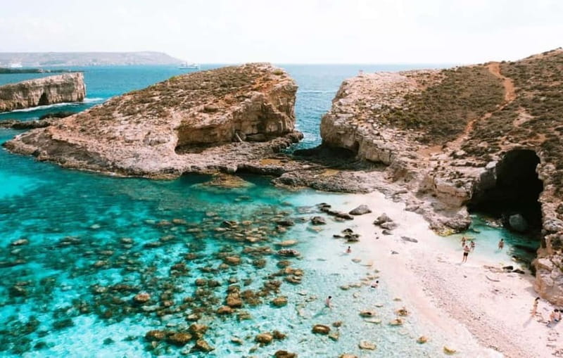 Comino & Gozo: Blue & Crystal Lagoons Cruise with Sea Caves - The first ride past Comino Tower