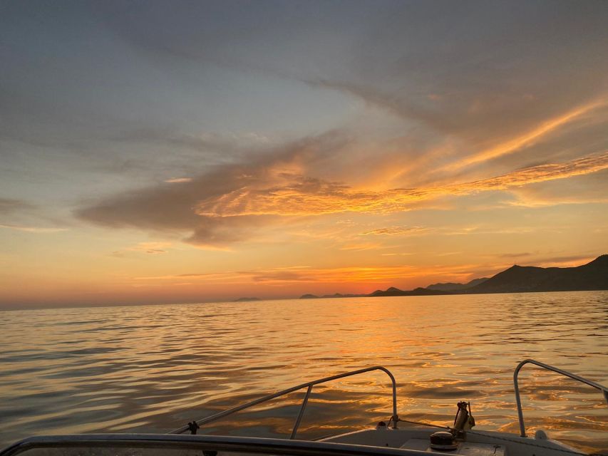 Dubrovnik: Romantic Sunset Cruise & Cave Visit with a Local - The first views: city walls, coast, and the Red Keep