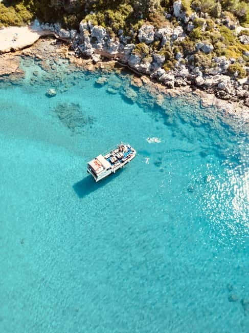 Faliraki: Boat Trip to Anthony Quinn & The Caves with Drinks - Finding the yellow boat at Faliraki beach