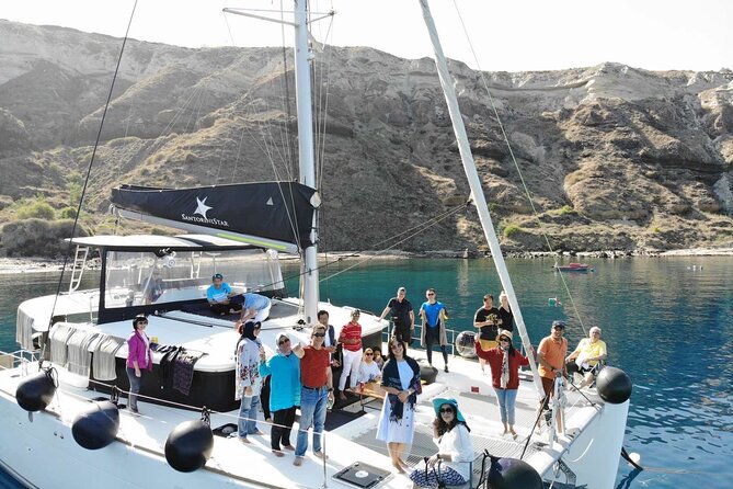 Half-Day Exclusive Catamaran Cruise in Santorini with Meal and Open Bar - Returning below Fira and the Black Mountain