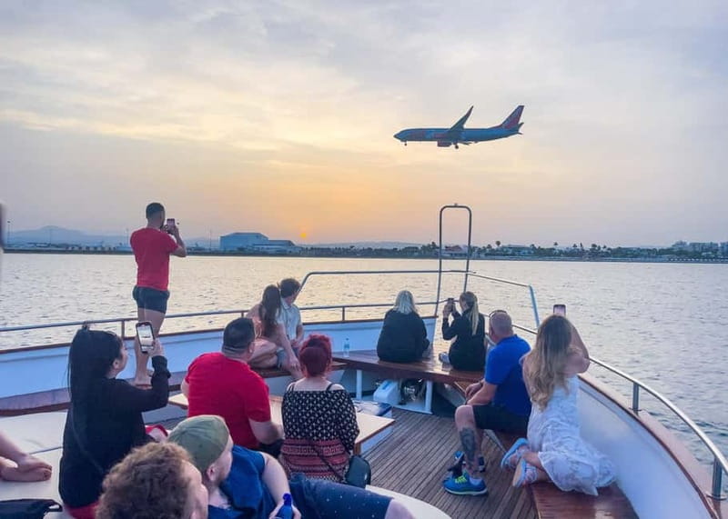 Larnaca: Sunset Cruise with a Glass of Wine - Mackenzie Beach, swimming, and planes overhead
