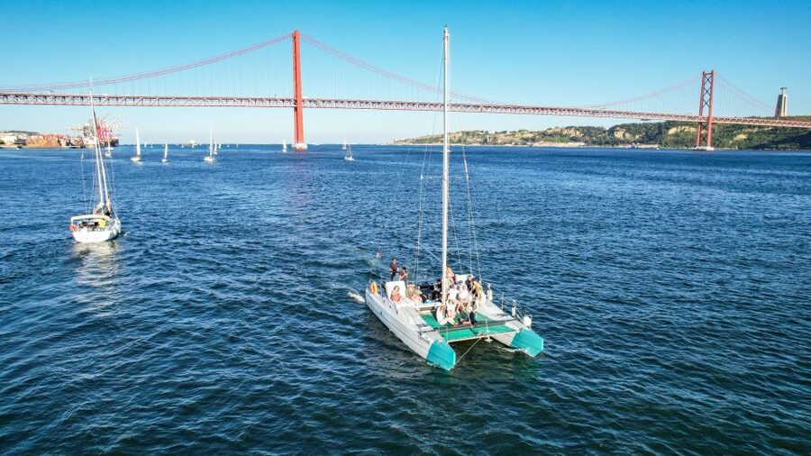 Lisbon: Sunset Catamaran Boat Tour with Music and Drinks - Music, drinks, and the onboard mood