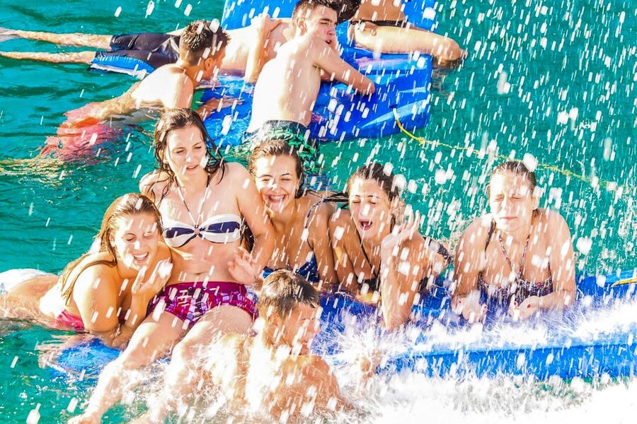 Lloret de Mar: Catamaran Sailing Cruise with BBQ and Drinks - Drinks, music, and the party atmosphere