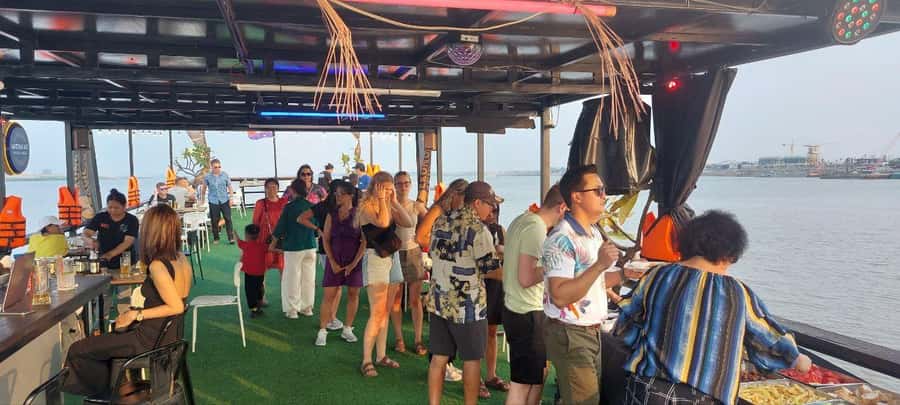 Phnom Penh: Sunset Cruise with Unlimited Beers & BBQ Buffet - Sunset, city lights, and the food on board