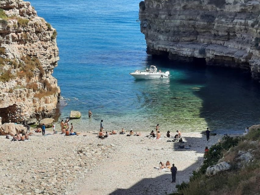 Polignano's coast and caves: a boat tour with drinks, swimming, music, and fun - Lama Monachile Beach from the water