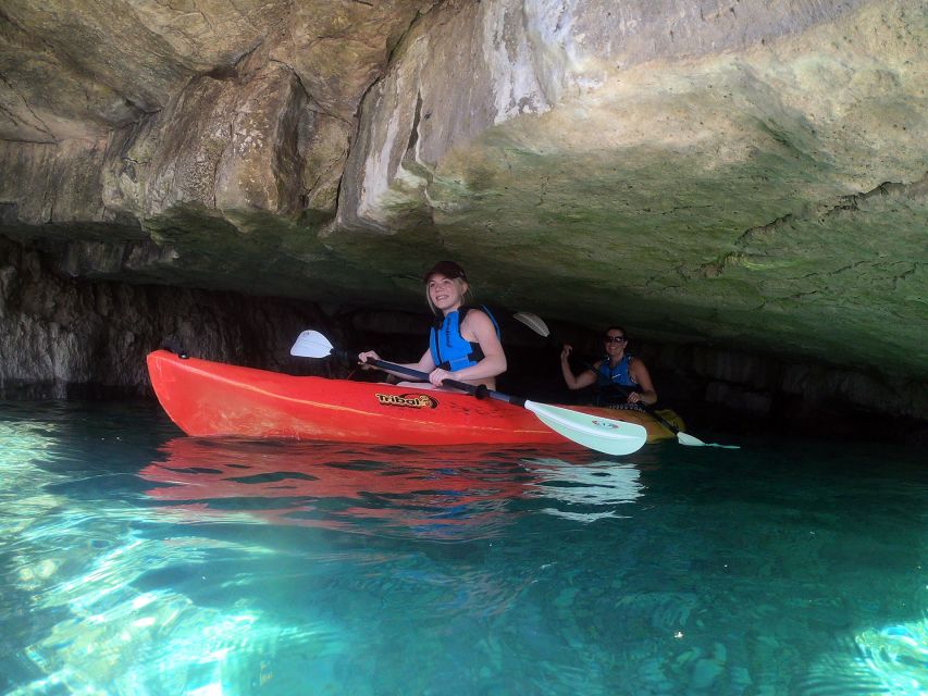 Pula: Sea Adventure – Boat, Kayak, Snorkeling & Cliff Jumps - Kayaking beside cliffs and into rocky passages