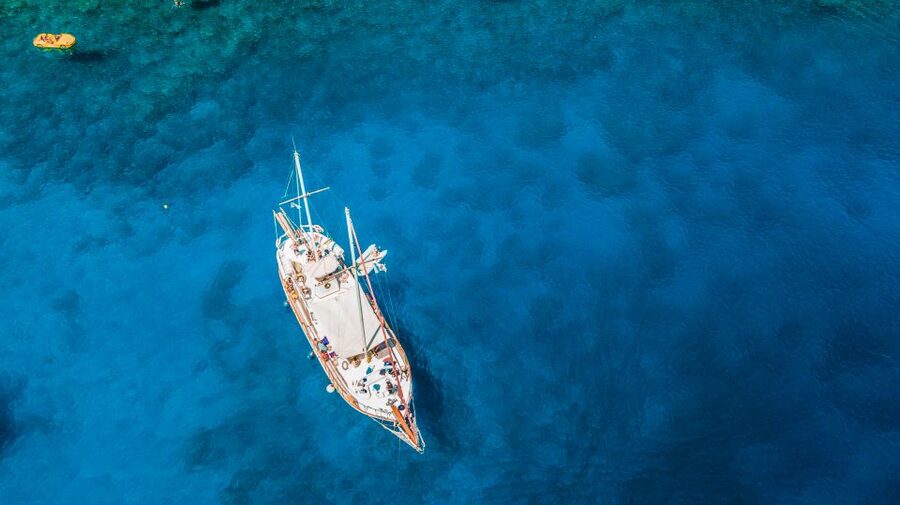 Rhodes: Cruise with 3 Stops, Lunch and Unlimited Drinks - Leaving Mandraki Port on a traditional wooden boat