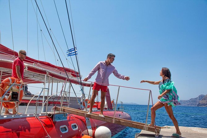 Sailing Catamaran Cruise in Santorini with BBQ, Drinks and Transfer - Red Beach from the water