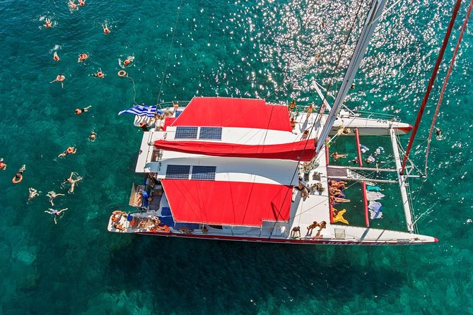 Sailing Catamaran Cruise in Santorini with BBQ, Drinks and Transfer - Pickup, ports, and the start of the cruise