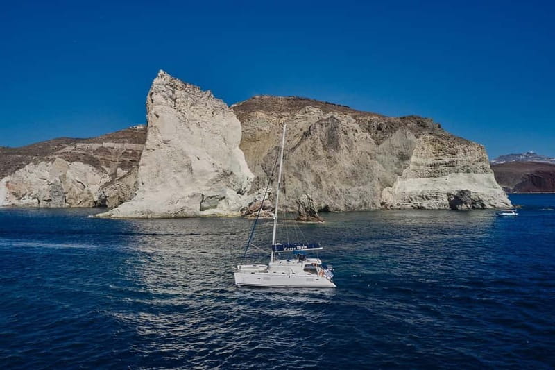 Santorini: Caldera Classic Catamaran Cruise w/ Meal & Drinks - Sailing past Indian Face and Akrotiri Lighthouse