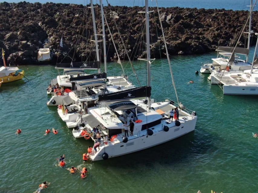 Santorini: Catamaran Cruise with Meal & Open Bar - Indian Rock, Black Mountain, and the sunset return