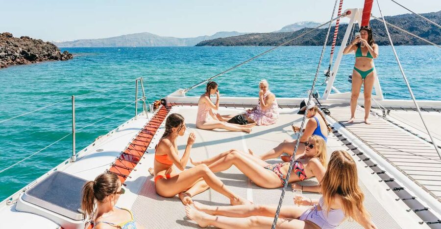 Santorini: Catamaran Tour with BBQ Dinner, Drinks, and Music - Red Beach, with time to swim and snorkel