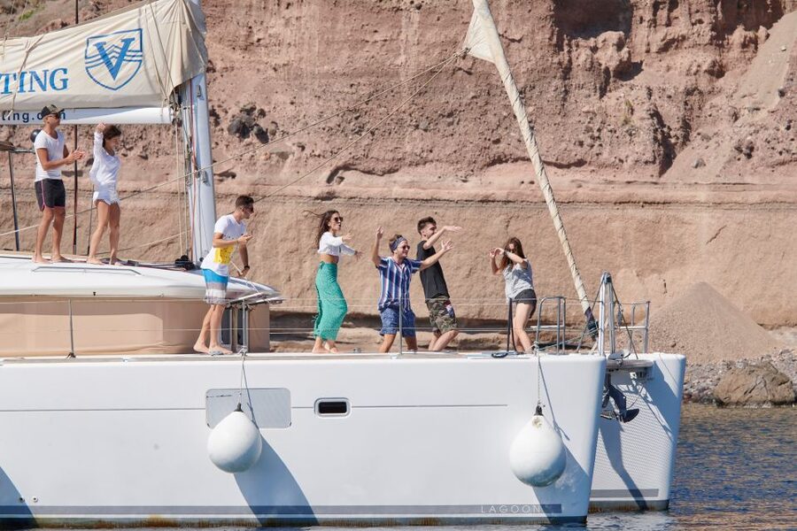 Santorini Gold Catamaran Cruise with Snorkel, BBQ & Open Bar - White Beach, the lighthouse, and the volcanic coast