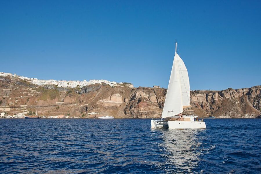 Santorini Gold Catamaran Cruise with Snorkel, BBQ & Open Bar - Mesa Pigadia and the onboard barbecue