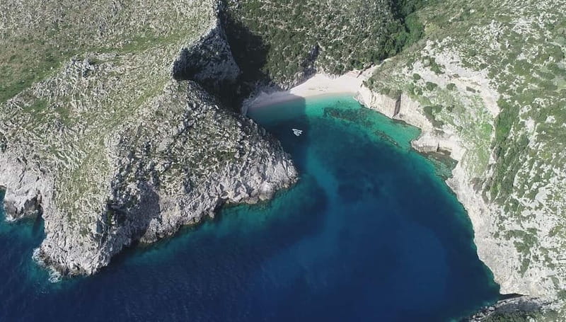 Secret Blue Cave & Grama Bay - Speed Boat Tour - Grama Bay: The Main Beach Break
