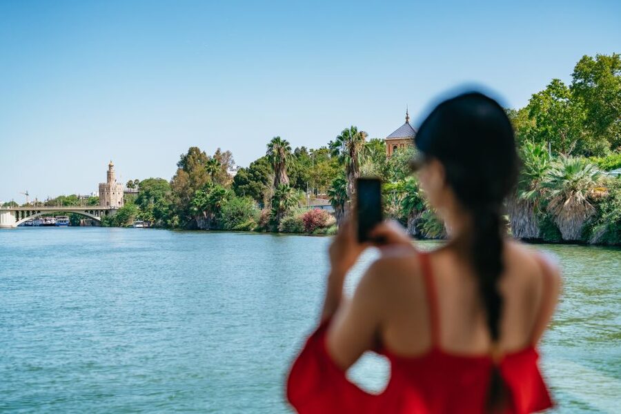 Seville: 1-Hour Guadalquivir River Sightseeing Eco Cruise - Old towers beside modern Seville