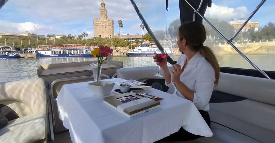 Seville: Exclusive River Boat Tour with Tapas - Triana Bridge and the old riverfront