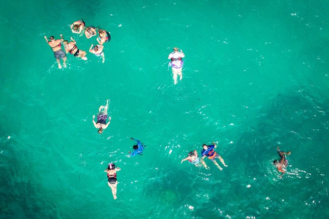 Small-Group Cruising and Snorkeling Catamaran Tour - Onboard Comfort, Music, and the Happy Fish Drink